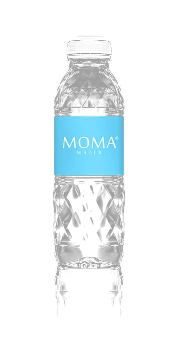 A MOMAwater bottle standing in a softly lit dark vitrine — square prism with 160 diamond facets.