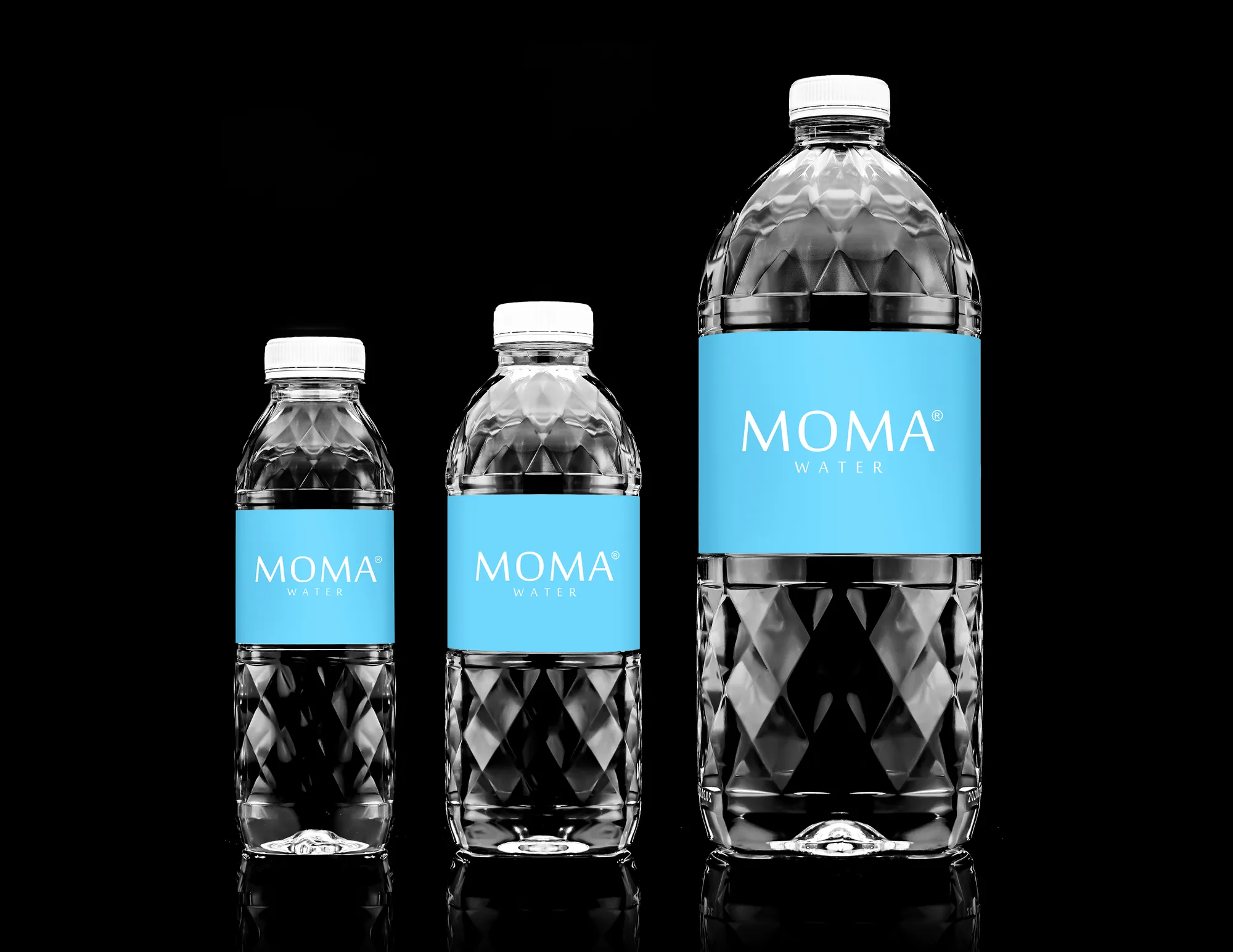 The MOMAwater range — 300mL, 500mL and 1500mL — on black.